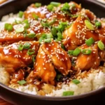 A close up, top-down view of a glistening bowl of Panda Express Teriyaki Chicken